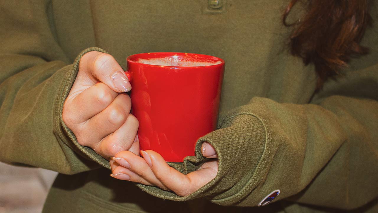 FreshGround employee holding a coffee