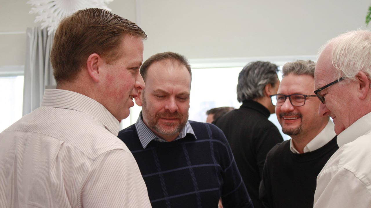 four male workers collaborating