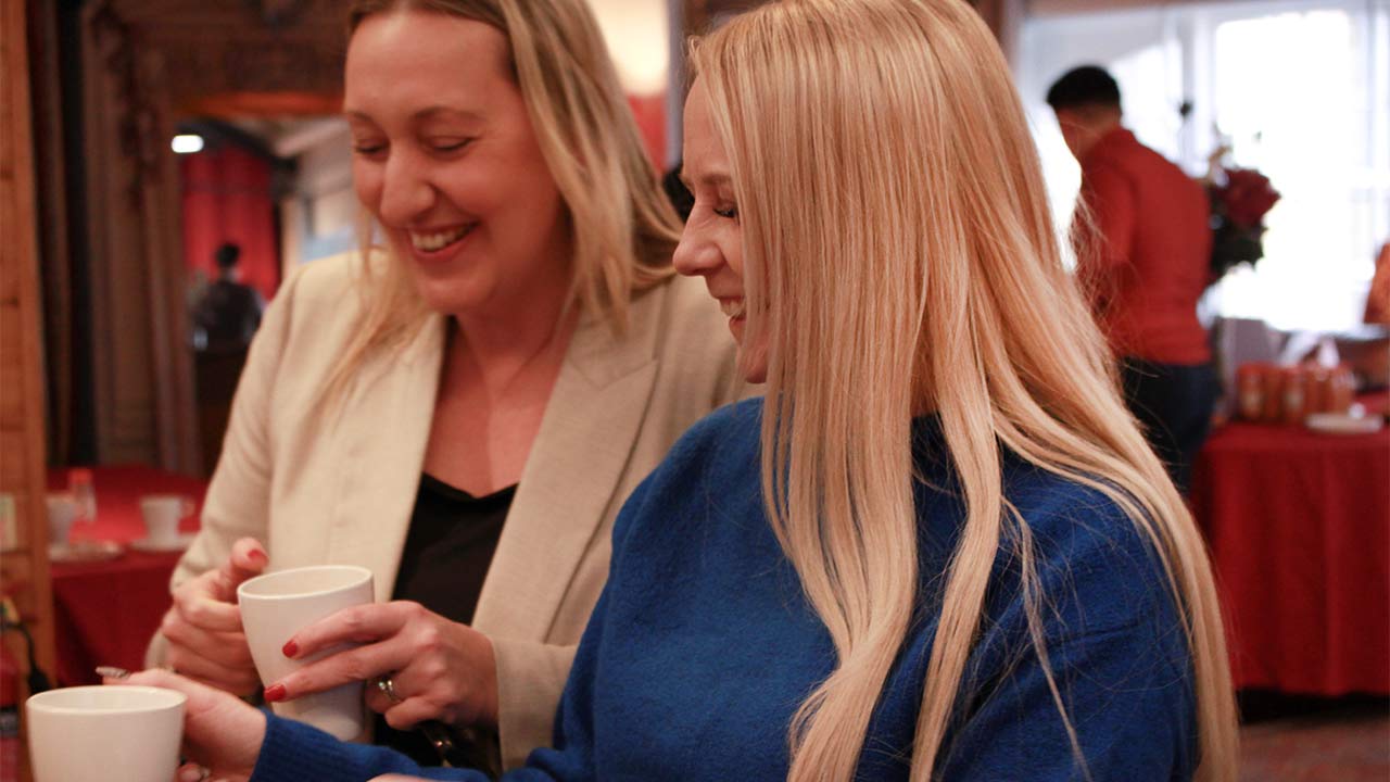 two FreshGround employees giggling on a work break