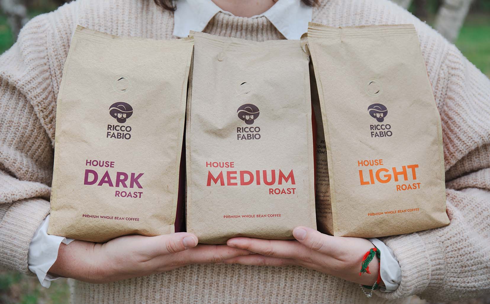 holding 3 bags of coffee beans to go in coffee machine