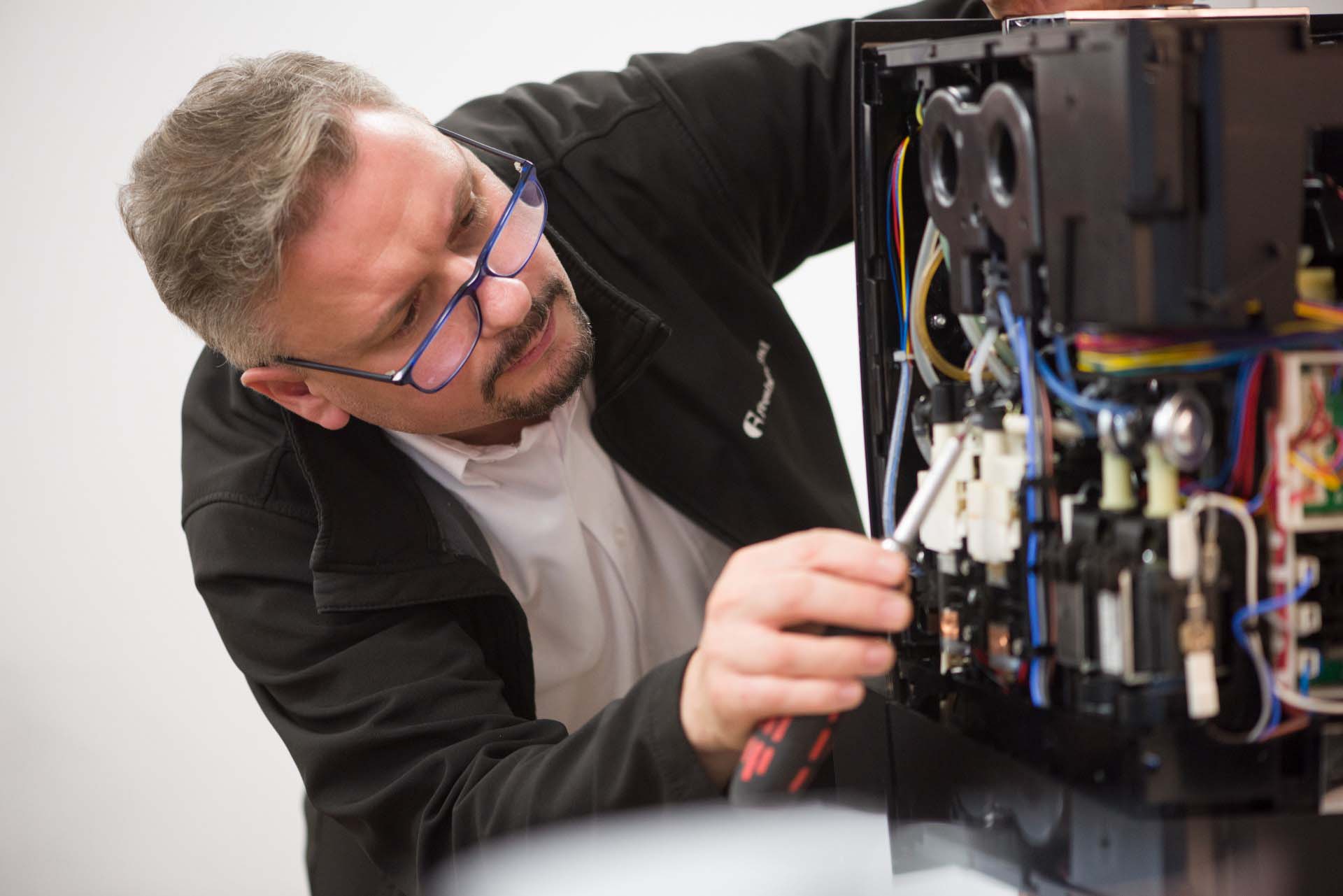 Engineer Slav works on a coffee machine, circular economy in practice, as this is what he does most days.