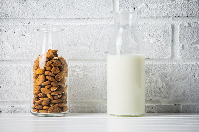 Jar of almonds next to jar of milk
